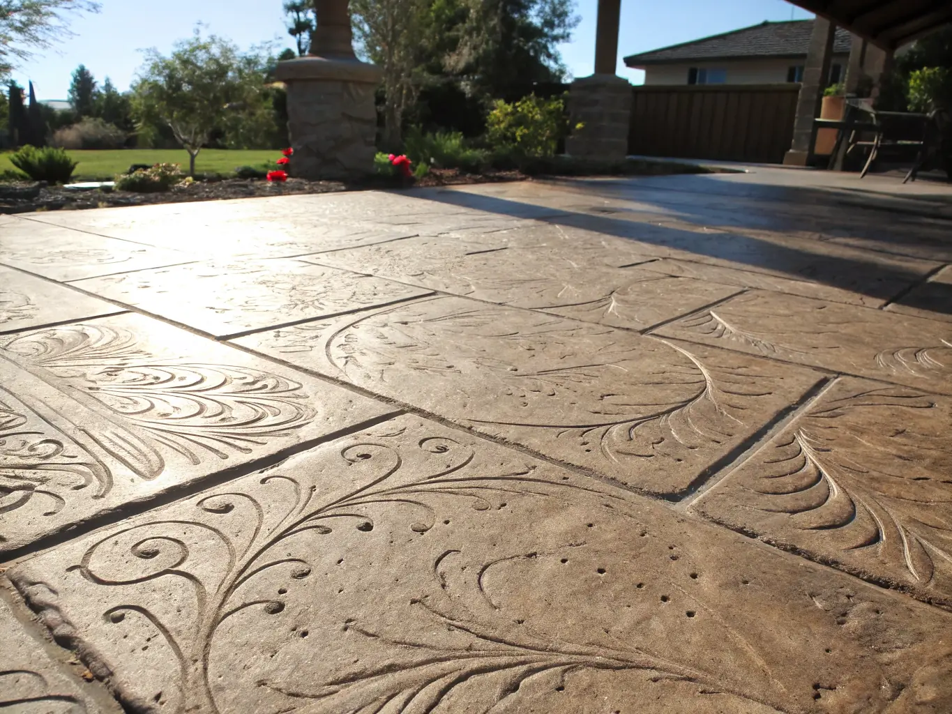 Close-up of decorative stamped concrete with intricate patterns and vibrant colors, highlighting Sandstone Concrete's expertise in creating unique and visually appealing concrete surfaces.