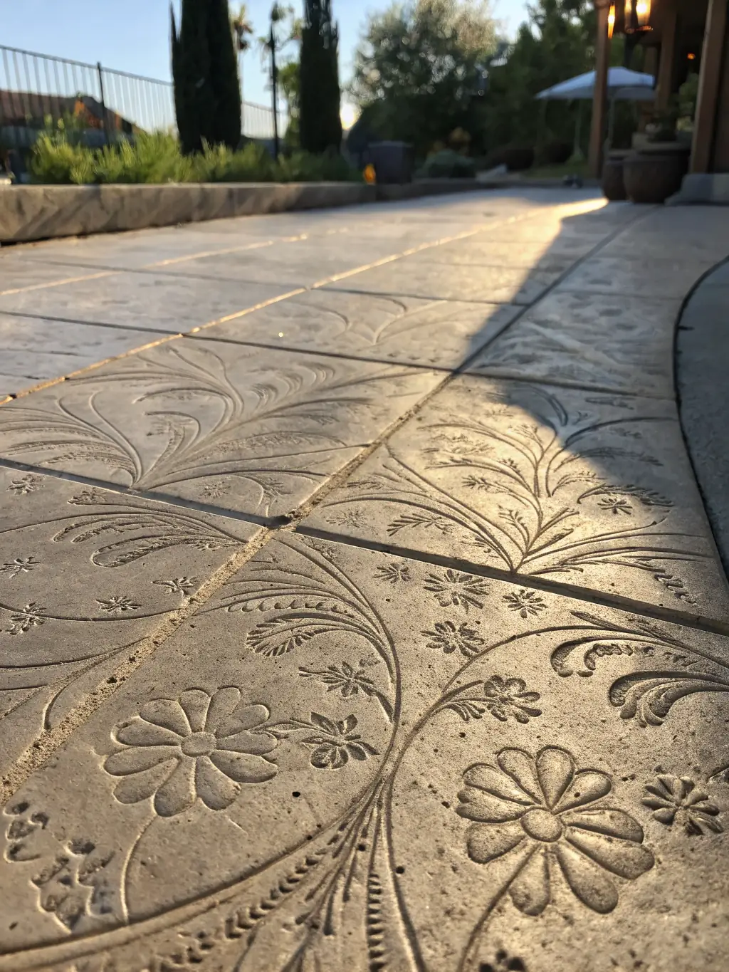 A close-up shot of stamped concrete with a decorative pattern resembling natural stone, highlighting Sandstone Concrete's custom concrete options.